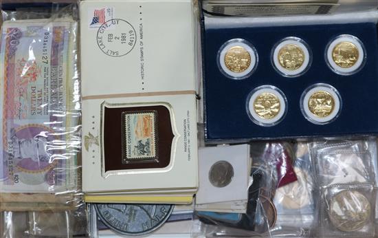 A collection of coins, banknotes and stamps,